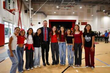 Sowers Middle School Principal Jeff Smith poses with students who volunteered to welcome guests during Wednesday’s ribbon-cutting event in Huntington Beach.